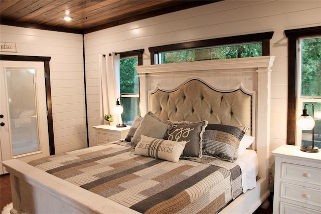 bedroom with wood walls and wood ceiling