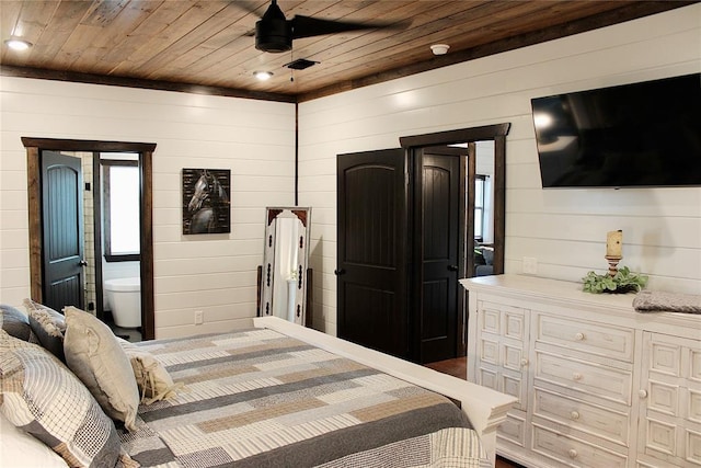 bedroom featuring wooden walls, ensuite bath, and wooden ceiling