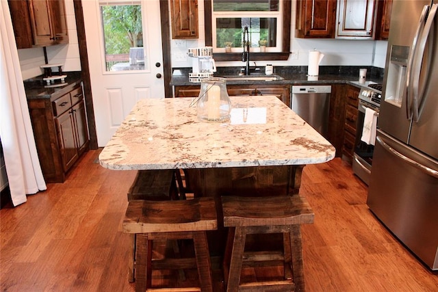 kitchen with plenty of natural light, a kitchen island, and stainless steel appliances