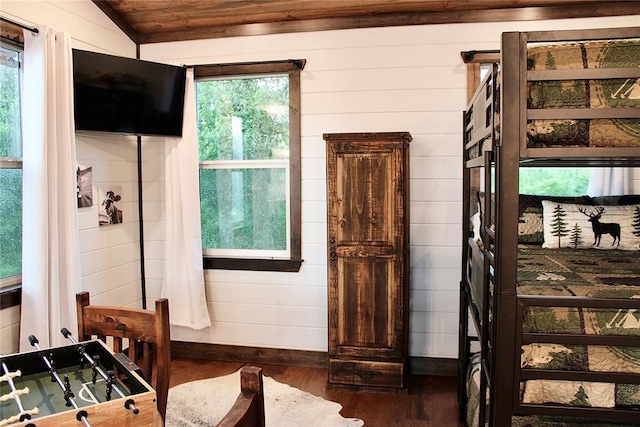 bedroom with dark hardwood / wood-style flooring, vaulted ceiling, multiple windows, and wooden ceiling