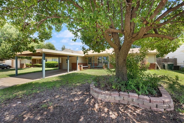 view of front of house with a carport and a front lawn