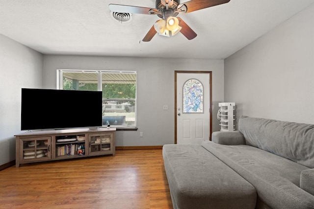 living room with hardwood / wood-style floors and ceiling fan