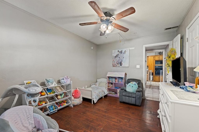 bedroom with ceiling fan and dark hardwood / wood-style floors