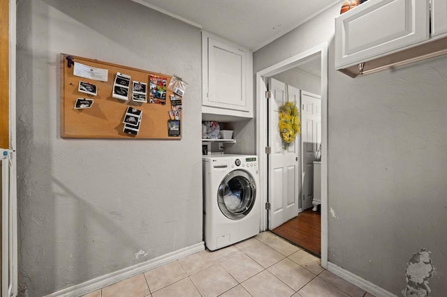 washroom featuring cabinets, washer / dryer, and light tile patterned floors