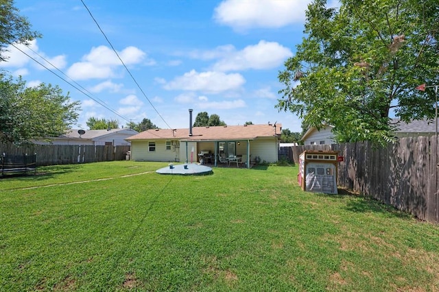 back of property with a lawn