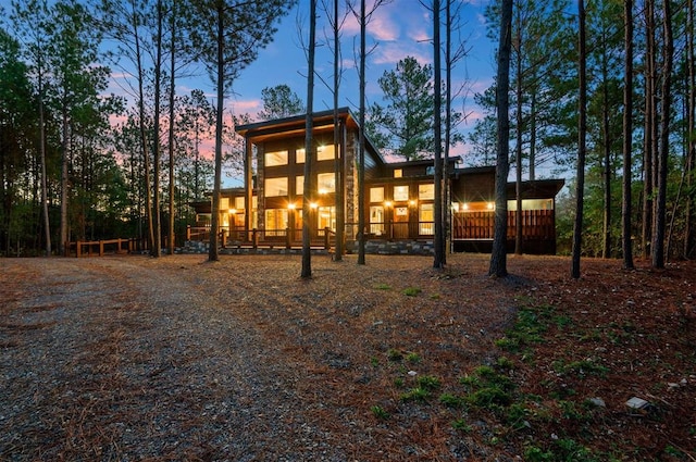 view of back house at dusk