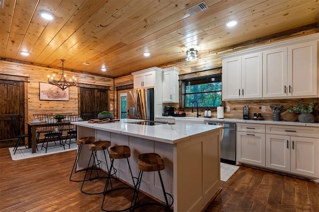 453 Bear Pine Trl, Broken Bow, OK 74728 - kitchen with stainless steel appliances, a kitchen island, dark wood-style floors, a chandelier, and recessed lighting