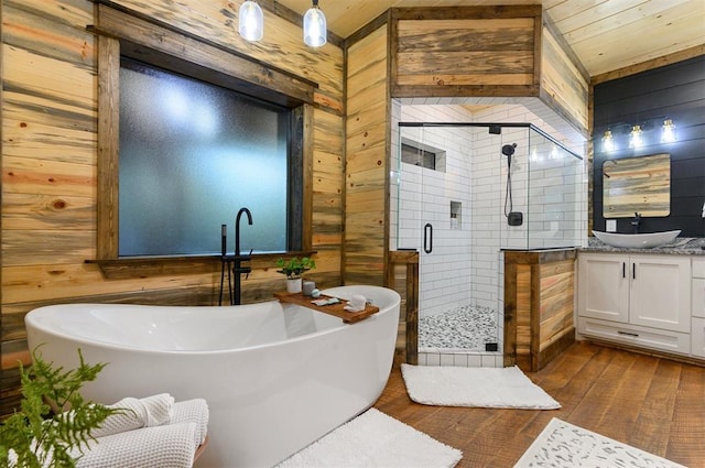 bathroom with wooden walls, wood-type flooring, vanity, separate shower and tub, and wooden ceiling