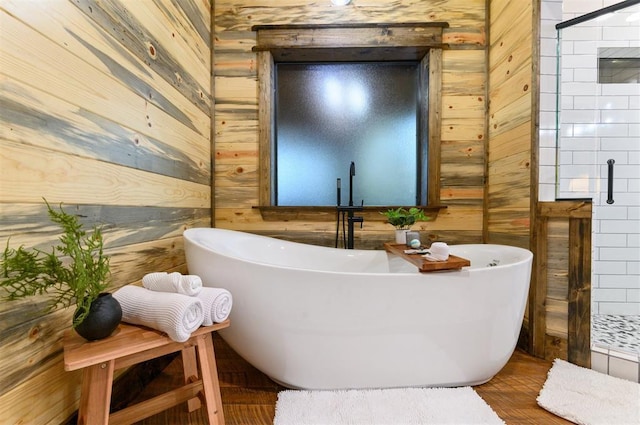 453 Bear Pine Trl, Broken Bow, OK 74728 - full bathroom with wooden walls, tiled shower, a soaking tub, and wood finished floors