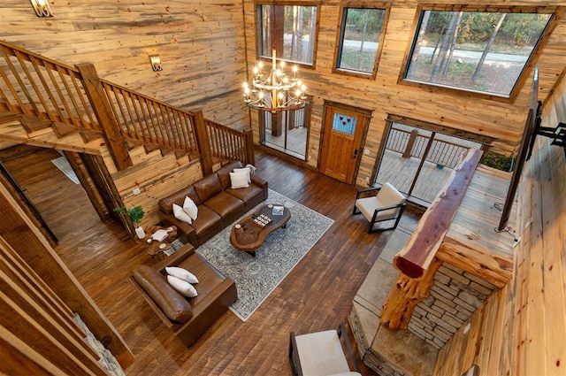 453 Bear Pine Trl, Broken Bow, OK 74728 - living area featuring wooden walls, dark wood finished floors, stairs, and a chandelier