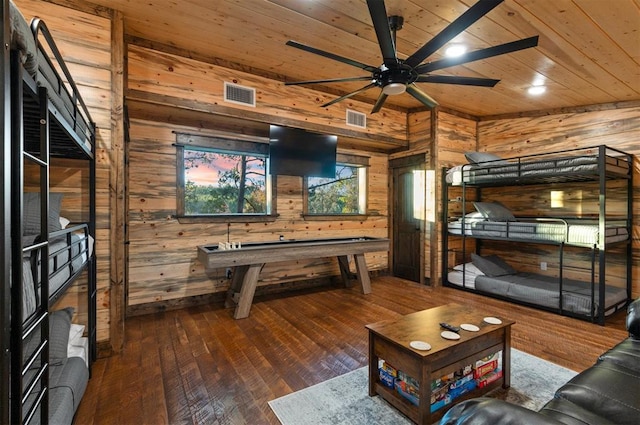 playroom with hardwood / wood-style floors, wood ceiling, ceiling fan, and wood walls