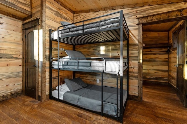 453 Bear Pine Trl, Broken Bow, OK 74728 - bedroom featuring wood walls, wood finished floors, and wooden ceiling