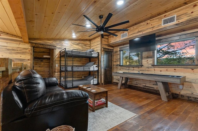 living room with dark hardwood / wood-style flooring, vaulted ceiling, wooden ceiling, and wood walls