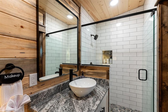 bathroom with vanity and a shower with door