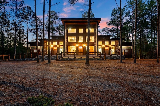 view of back house at dusk