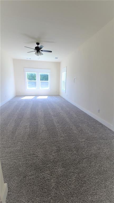 carpeted empty room with ceiling fan