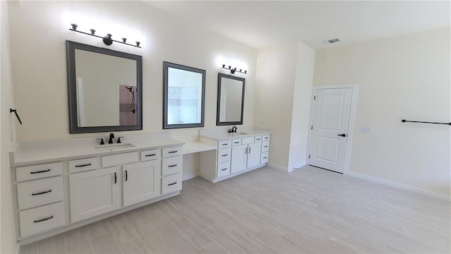 bathroom with vanity and hardwood / wood-style flooring