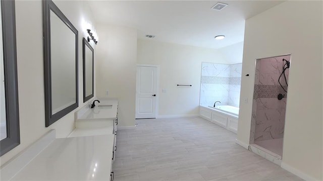 bathroom featuring vanity and plus walk in shower