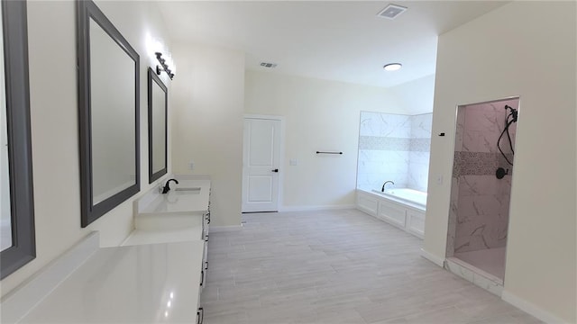 108 Tralee Ct, Yukon, OK 73099 - full bathroom featuring a bath, double vanity, a marble finish shower, wood finished floors, and baseboards