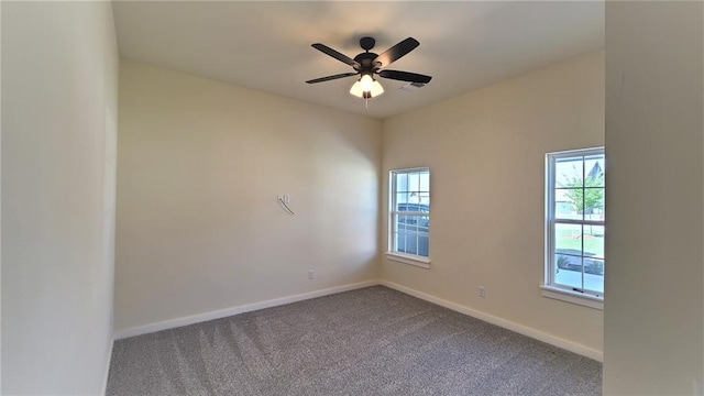 carpeted empty room with ceiling fan and a healthy amount of sunlight