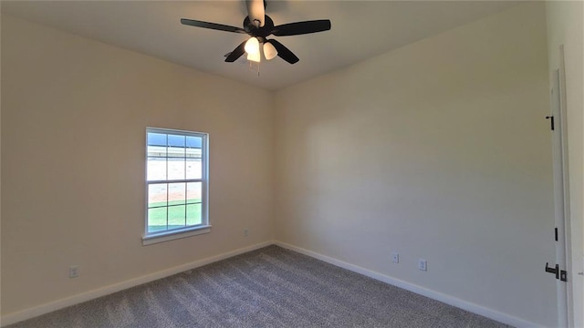 empty room featuring ceiling fan and carpet