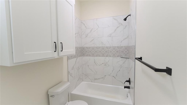 bathroom featuring toilet and tiled shower / bath