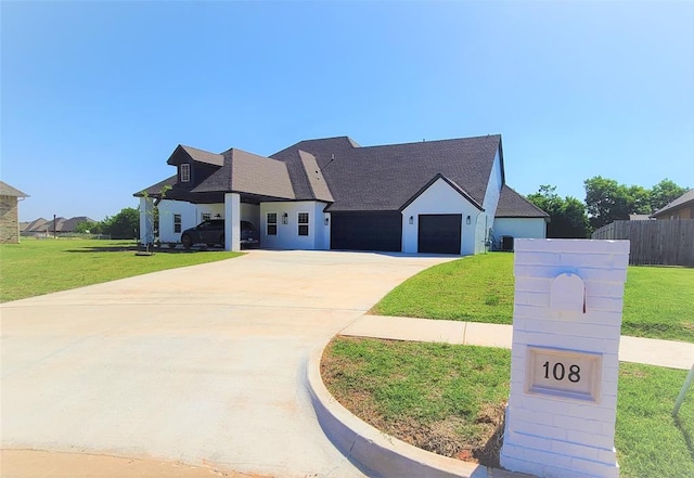 view of front of property with a garage and a front lawn