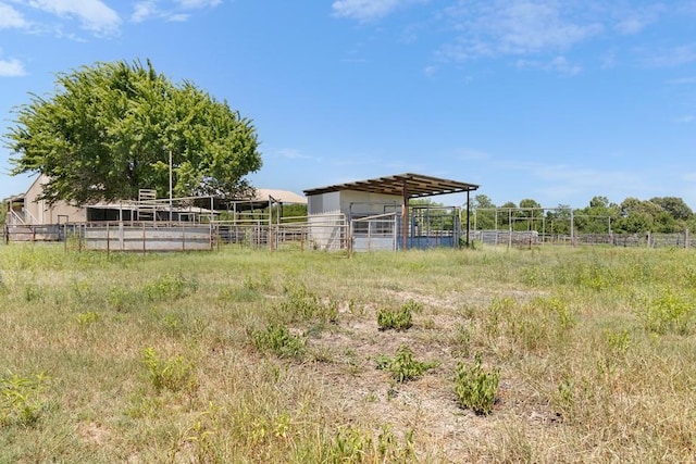 view of yard with a rural view and an outdoor structure