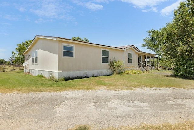 view of side of home featuring a lawn