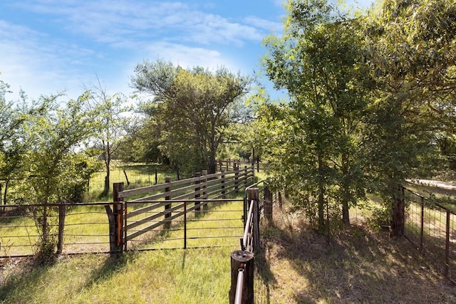 view of gate with a rural view