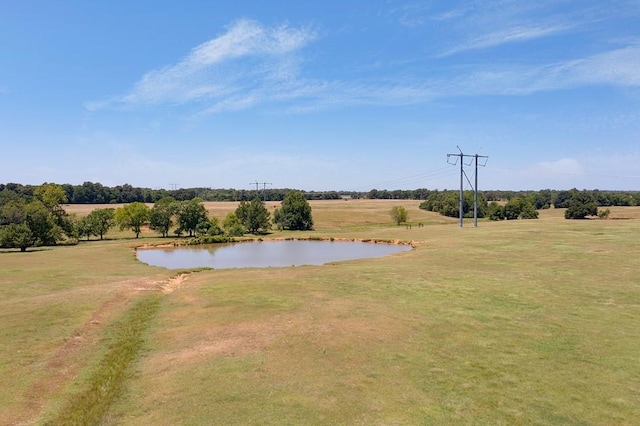 exterior space with a yard, a water view, and a rural view