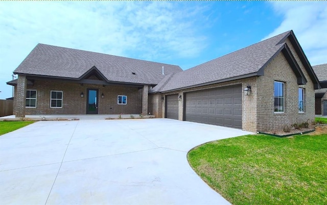 view of front of home with a front lawn and a garage