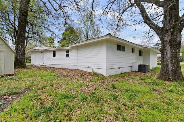 rear view of house featuring central AC