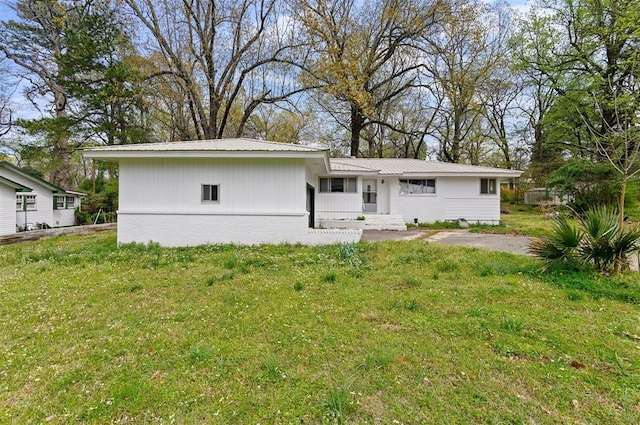 rear view of house with a porch and a yard