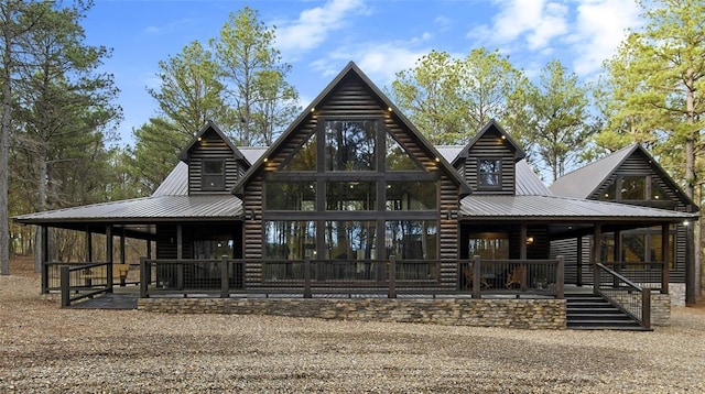 exterior space with metal roof and faux log siding