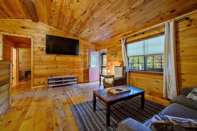 living room with wood walls, wooden ceiling, lofted ceiling with beams, and light wood-type flooring