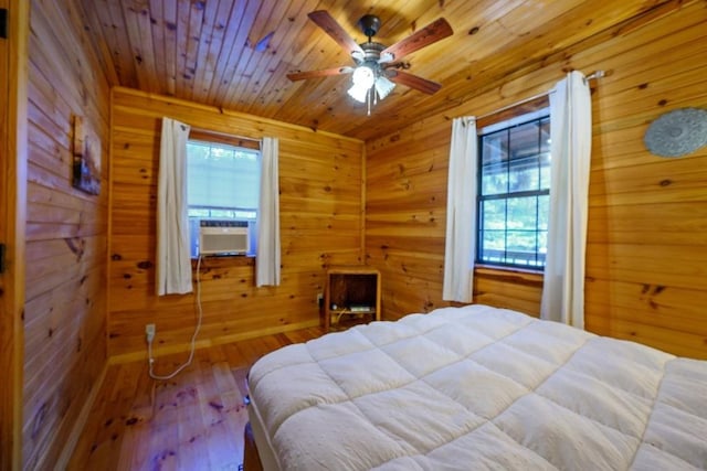 bedroom featuring hardwood / wood-style floors, ceiling fan, wooden ceiling, and wood walls