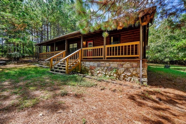 rear view of house featuring a porch