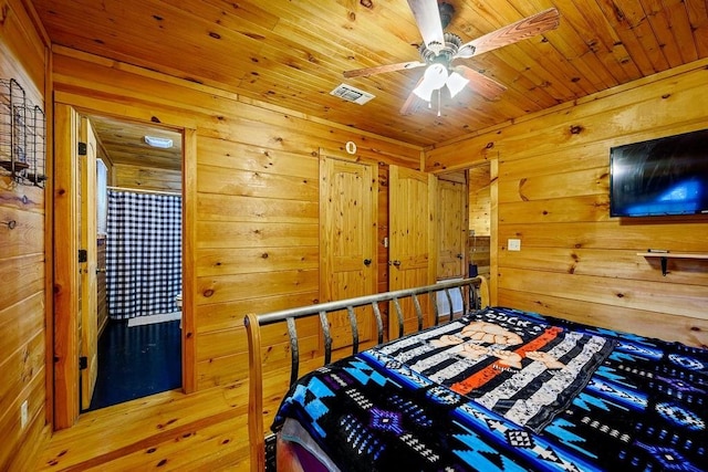 bedroom featuring wooden walls, ceiling fan, wooden ceiling, and hardwood / wood-style flooring