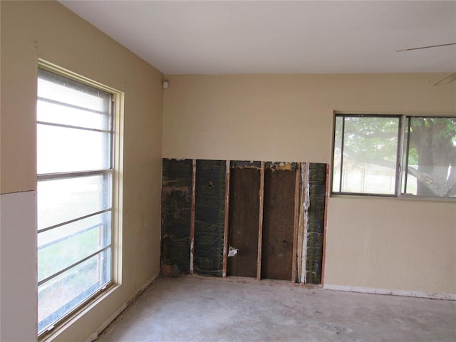 empty room with plenty of natural light and concrete floors