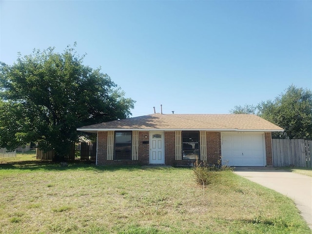 view of front of property with a front yard and a garage