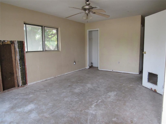 empty room with concrete flooring and ceiling fan