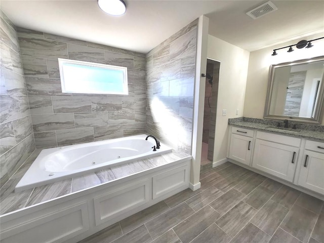 bathroom with vanity and plus walk in shower