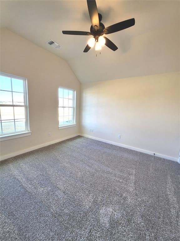 unfurnished room with ceiling fan, carpet, and lofted ceiling