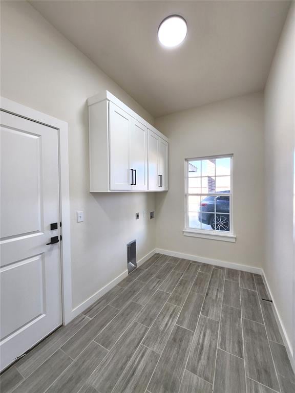 washroom featuring cabinets and hookup for an electric dryer