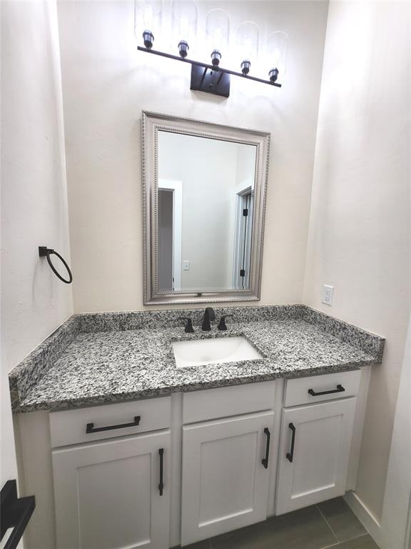 bathroom featuring tile patterned flooring and vanity