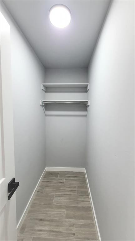 walk in closet featuring hardwood / wood-style floors