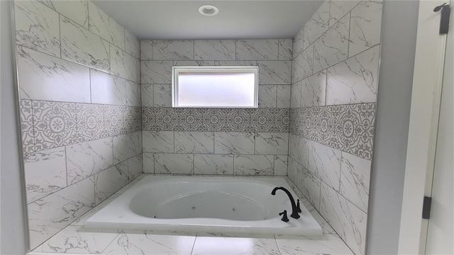 bathroom featuring a relaxing tiled tub