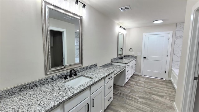 bathroom with hardwood / wood-style floors and vanity