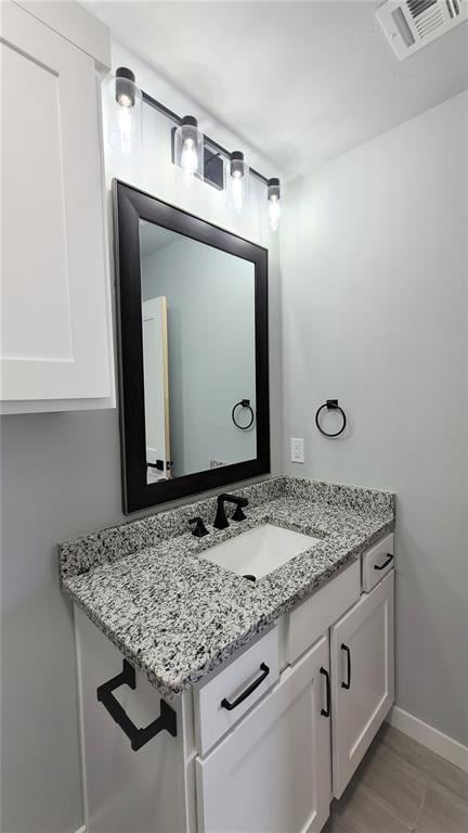 bathroom featuring vanity and wood-type flooring